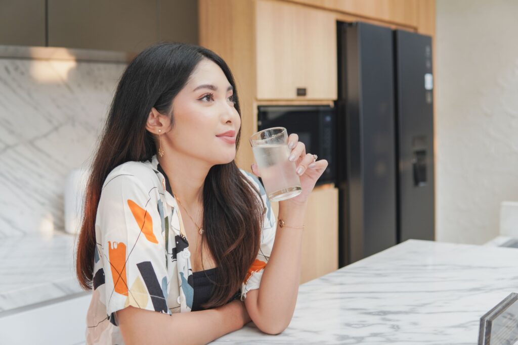 A woman enjoy drinking cold water