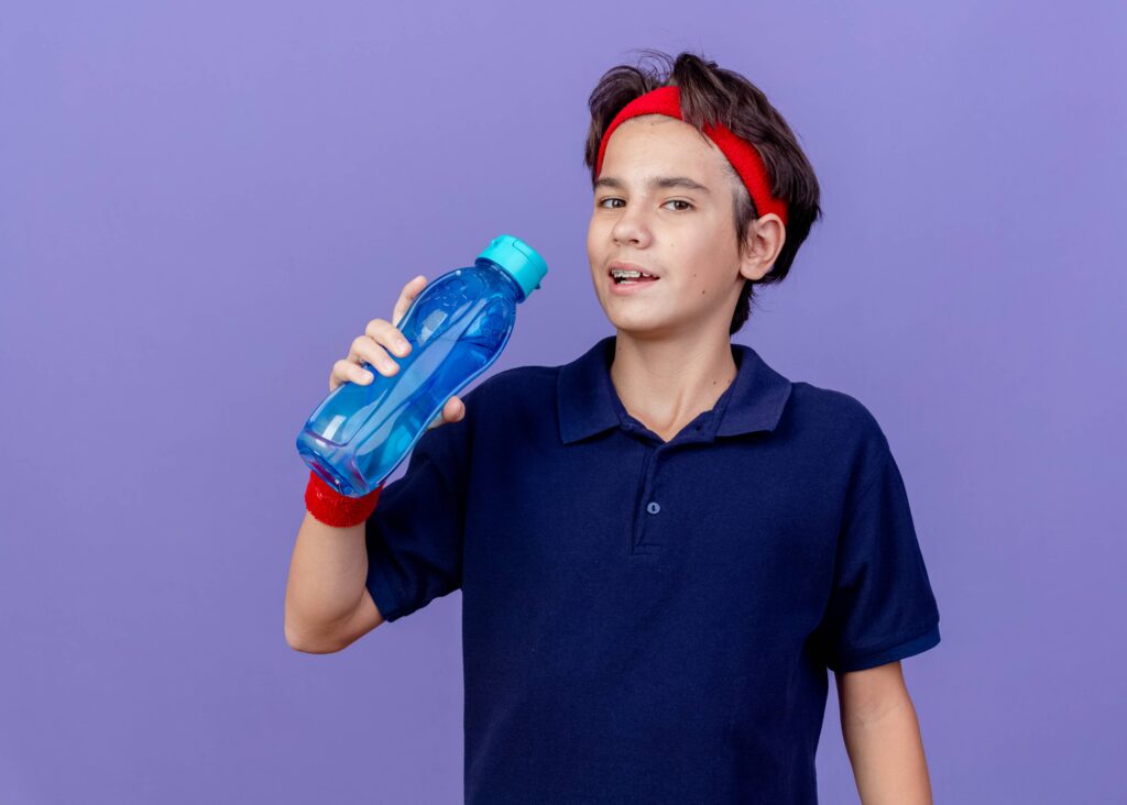 Sporty boy refill water using water dispenser